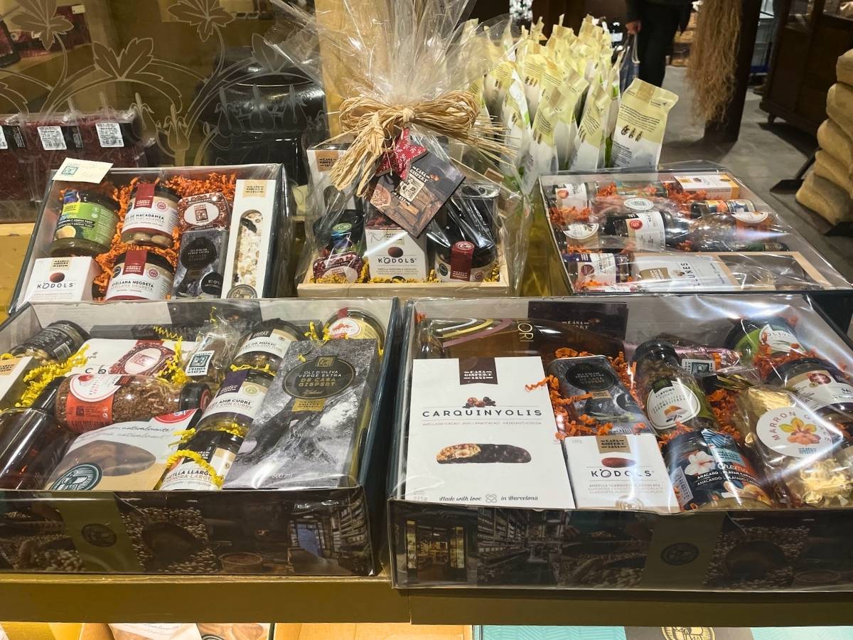 Gift baskets filled with dried fruits, nuts, olive oil, sweets, and gourmet food products for sale at Casa Gispert in Barcelona