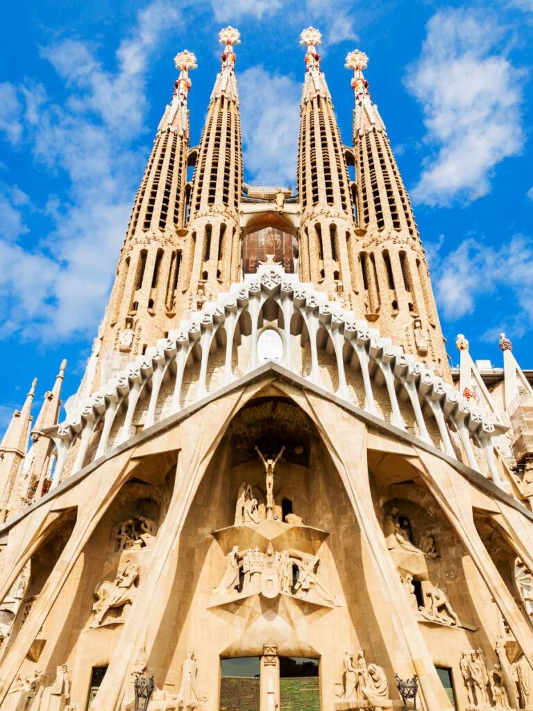 The exterior of the Sagrada Familia church in Barcelona, Spain with intricate towers and carvings