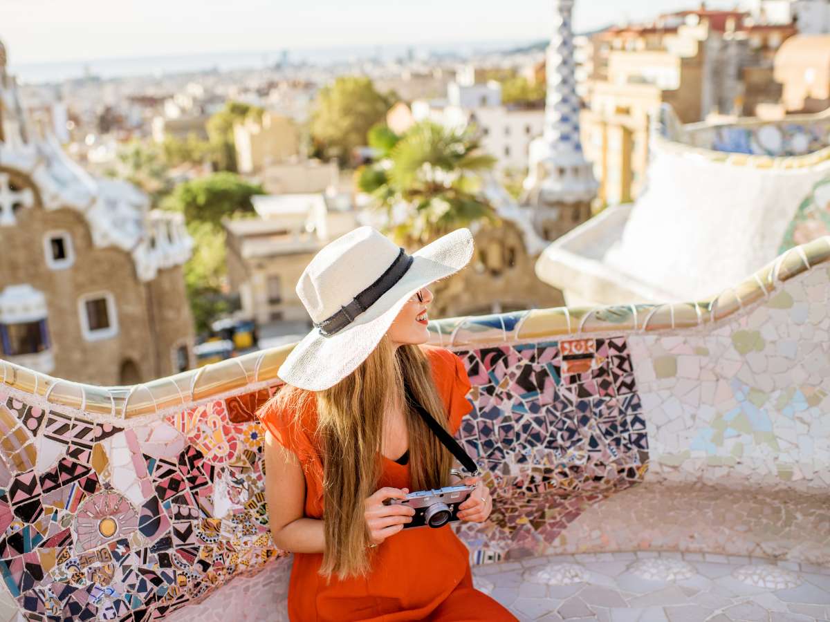 A woman dressed in a sun dress at Park Guell in Barcelona Spain