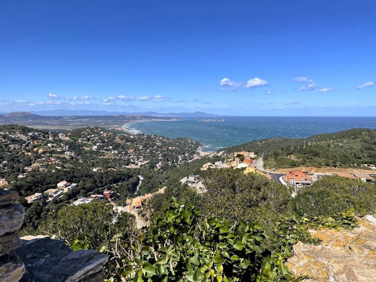 Elevated panoramic view of Begur coastline with hills houses and a wide bay