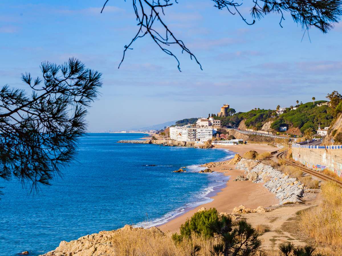 A view of the beach and coastline in Sant Pol de Mar, one of the best day trips from Barcelona Spain