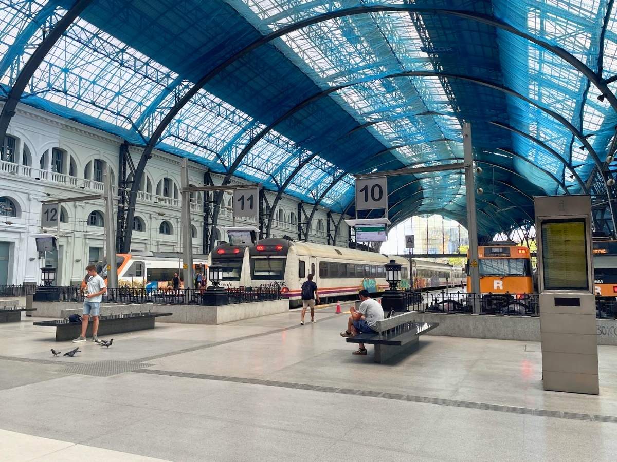 Trains parked at the platforms inside Estacio de França train station in Barcelona beneath a large arched glass and steel roof