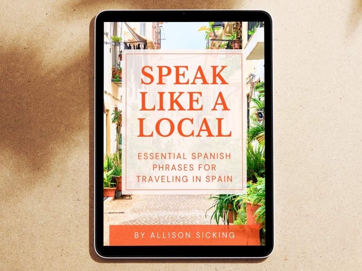 Tablet displaying the cover of the Speak Like a Local ebook, featuring essential Spanish phrases for traveling in Spain
