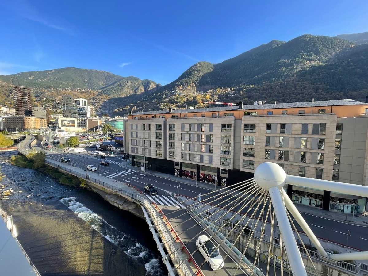 A view of buildings in downtown Andorra La Vella with mountains in the background