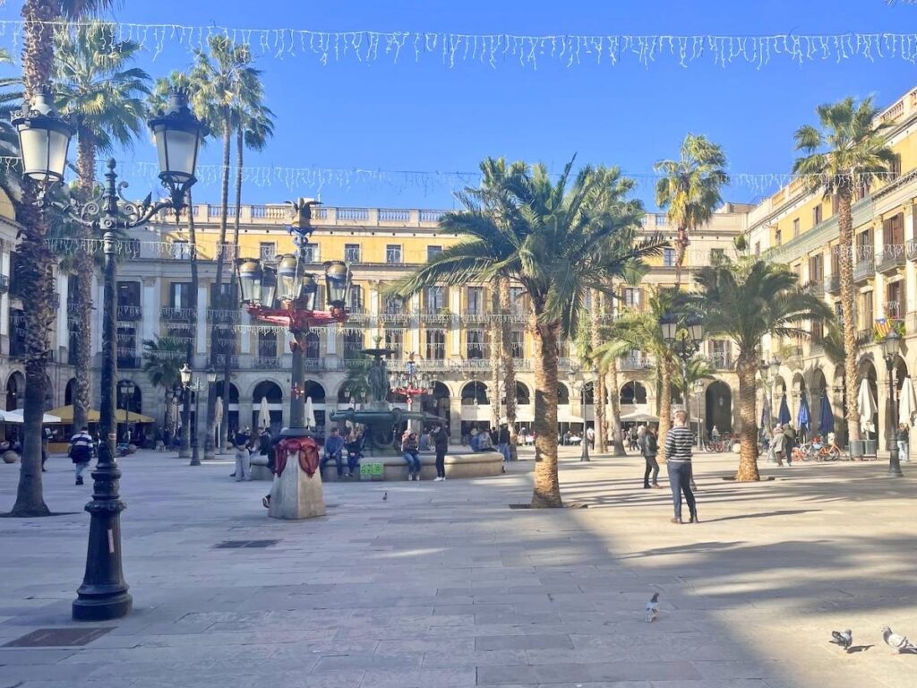 Palm trees and Christmas lights decorating Plaça Reial in Barcelona's Gothic Quarter