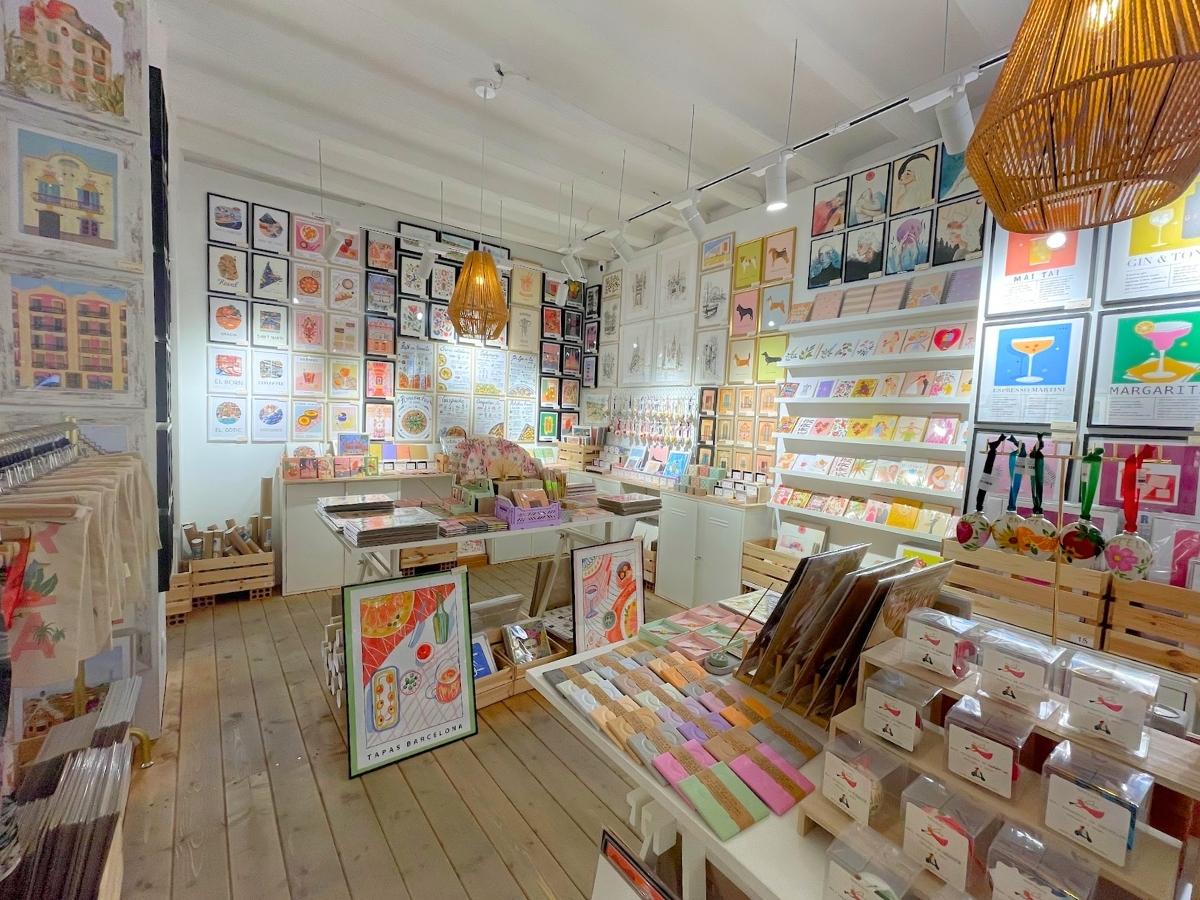 Artwork, jewelry, and Barcelona gifts on display at Mercilona souvenir shop in Barcelona Spain