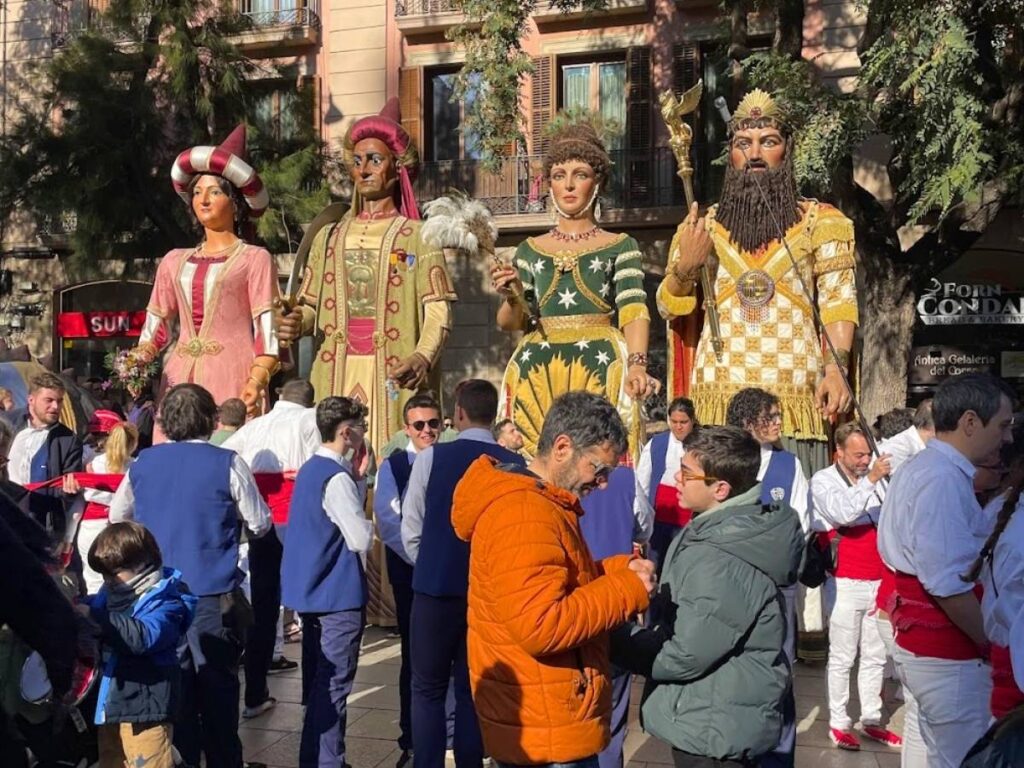 Traditional Catalan giant figures parading through the streets of Barcelona during the Santa Eulalia festival