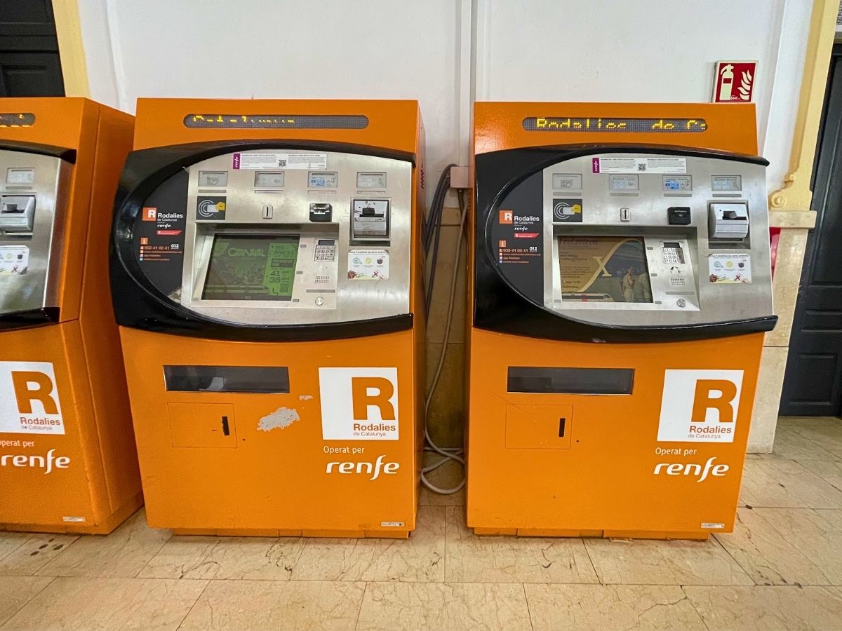 Orange ticket machines for Rodalies trains in Sitges Spain