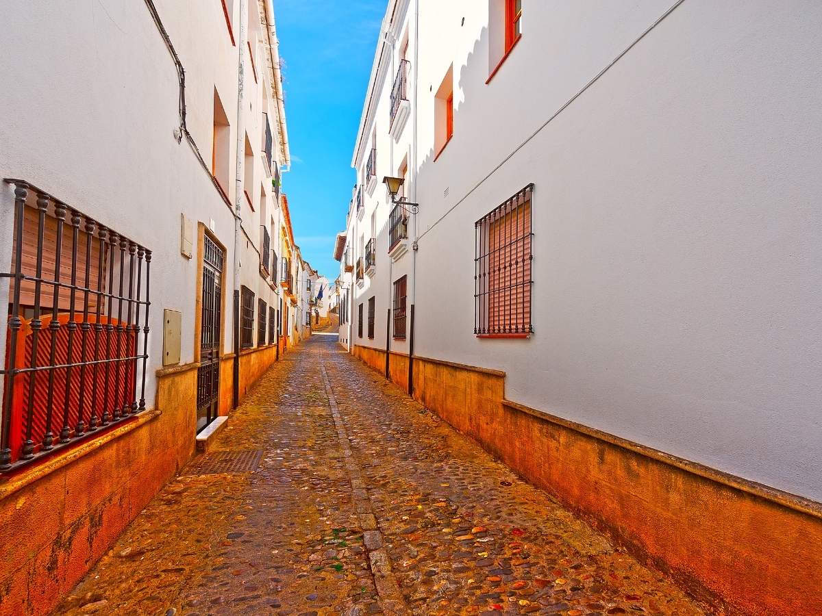 A deserted street with historic buildings during siesta in Spain