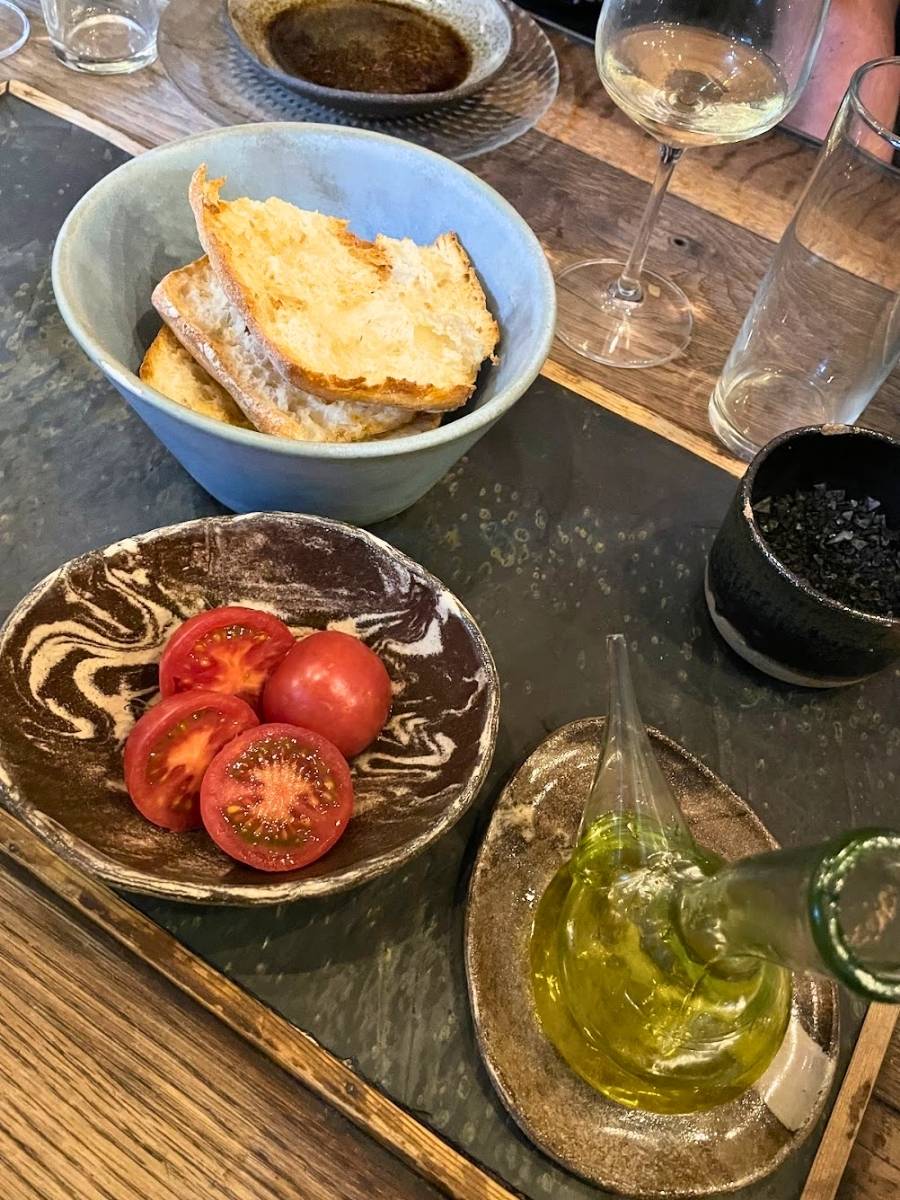 Bread, tomatoes, and a porron of olive oil to prepare pan con tomate