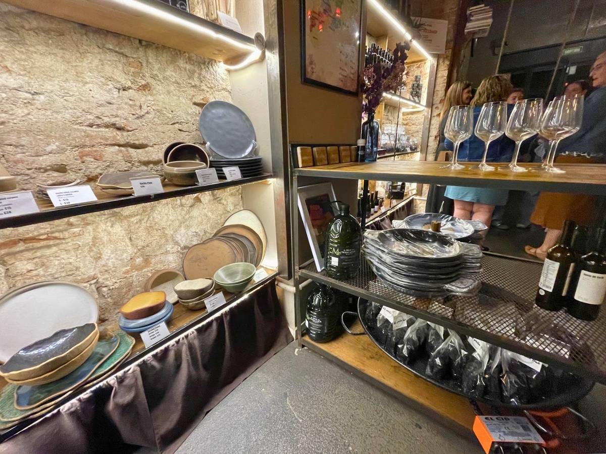 Shelves of paella pans and dishes for sale at the Paella Club Barcelona