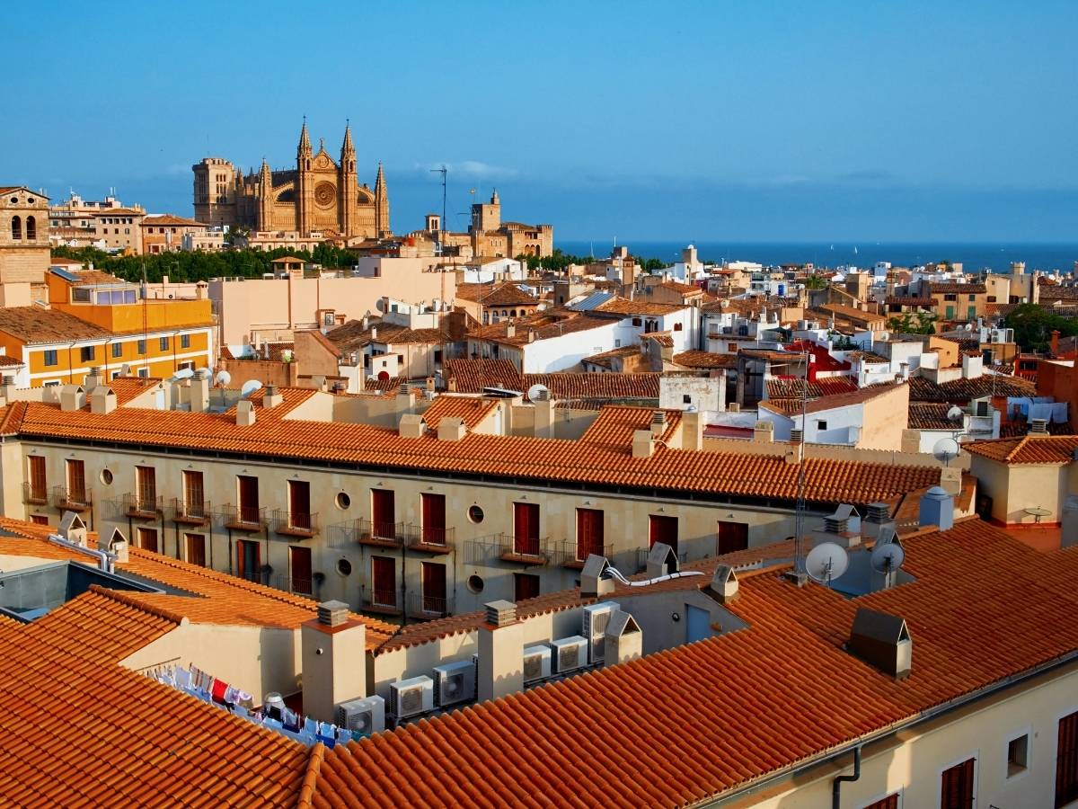 Palma de Mallorca skyline with La Seu Cathedral rising above terracotta rooftops and the sea in the background