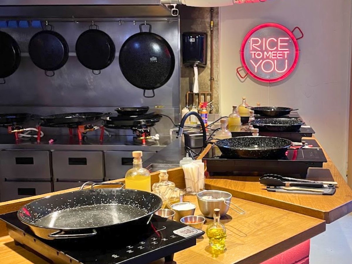 Individual paella cooking stations inside the modern Rice to Meet You kitchen in Barcelona