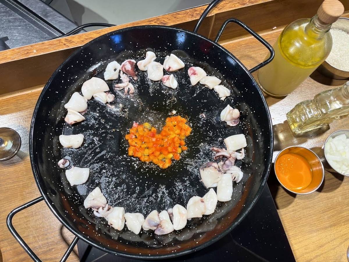 Seafood cooking in a paella pan during the Rice to Meet You Barcelona cooking class