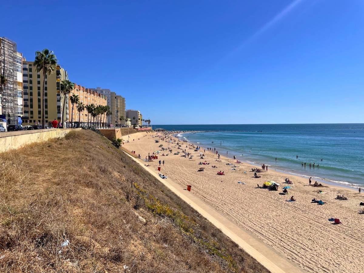 Playa de Santa María del Mar with a wide sandy beach and apartment buildings along the waterfront in Cádiz