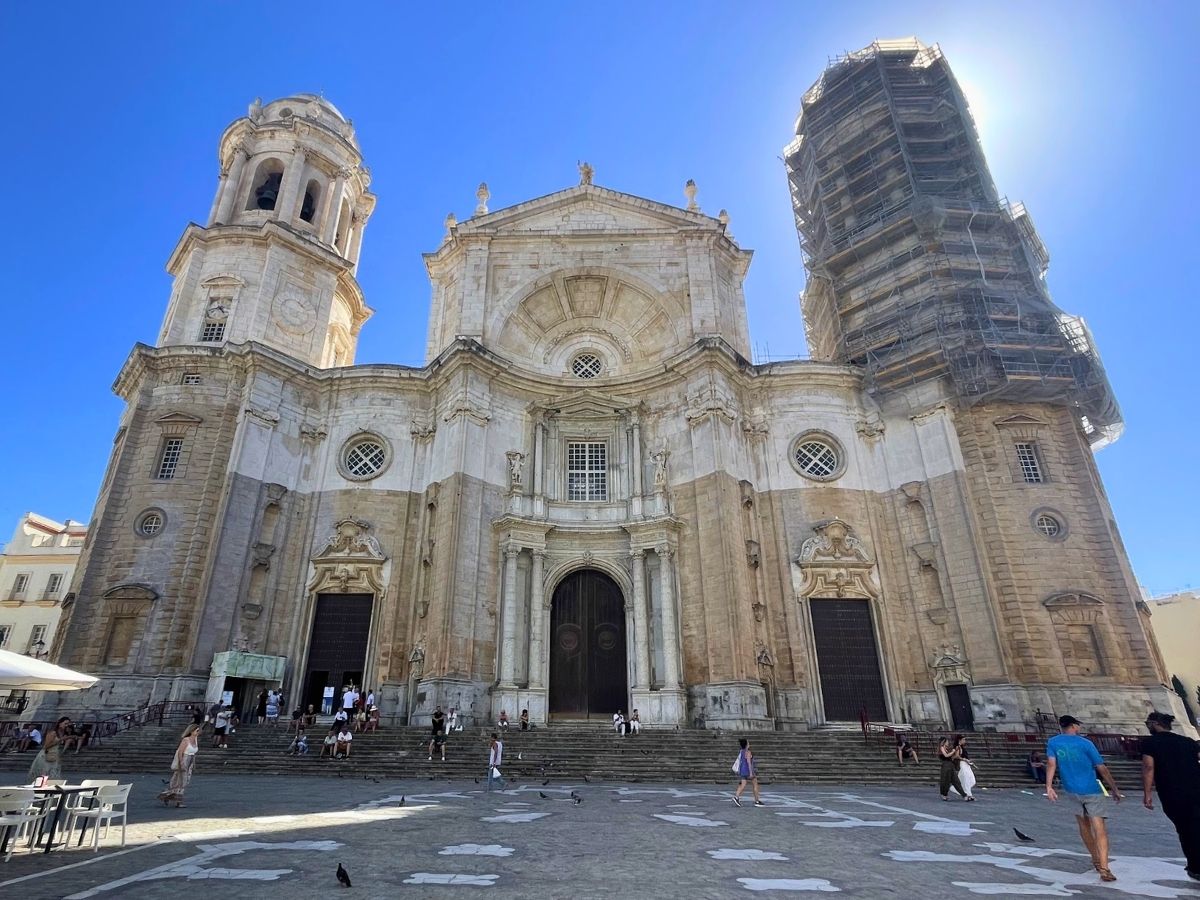 Front facade of Cádiz Cathedral under a bright blue sky