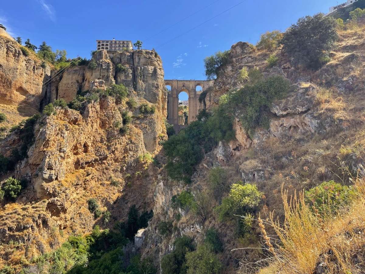 Puente Nuevo seen from below between the rocky cliffs of El Tajo gorge in Ronda