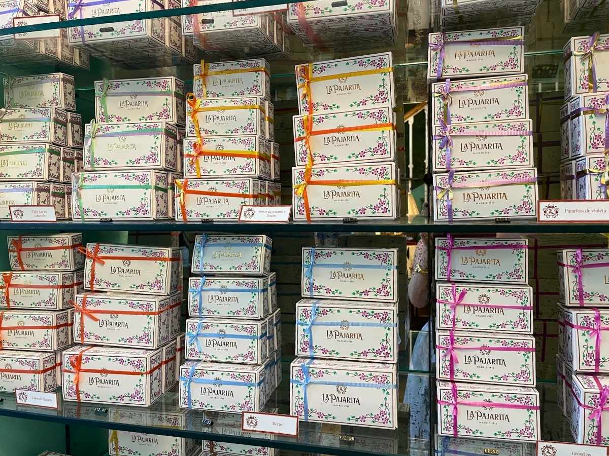 Decorative boxes of La Pajarita candies tied with colorful ribbons on display in Madrid