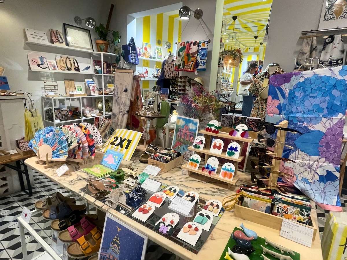 Colorful gifts, prints, jewelry, fans, accessories, and souvenirs inside La Peseta in Madrid