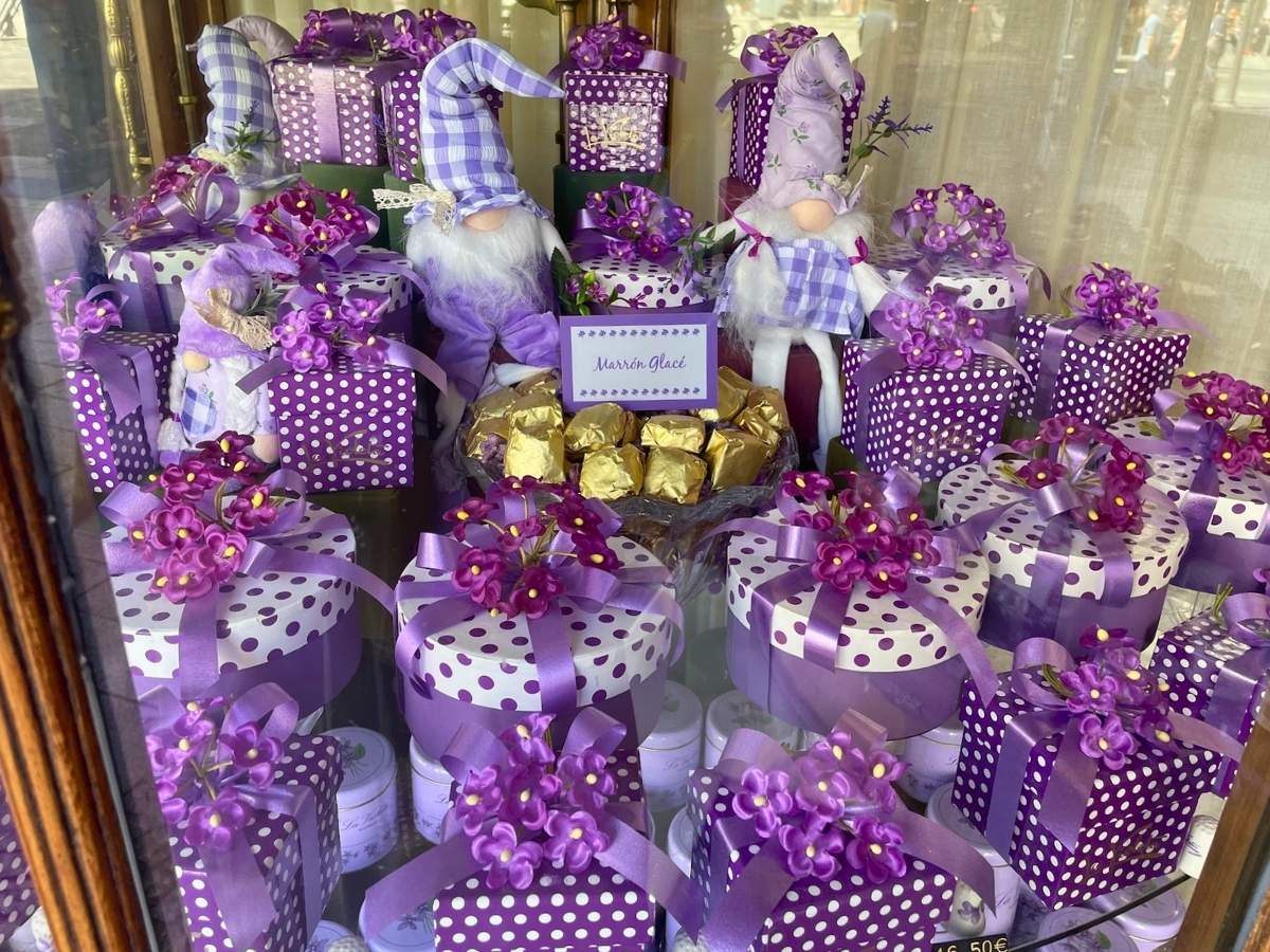 Purple gift boxes decorated with violet flowers in the window of historic La Violeta candy shop in Madrid