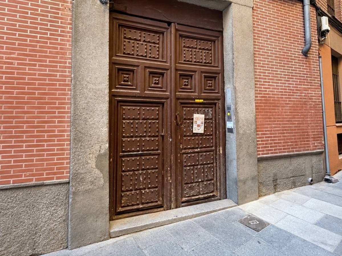 Wooden entrance door to the Madrid convent where visitors can buy traditional cookies and sweets made by nuns
