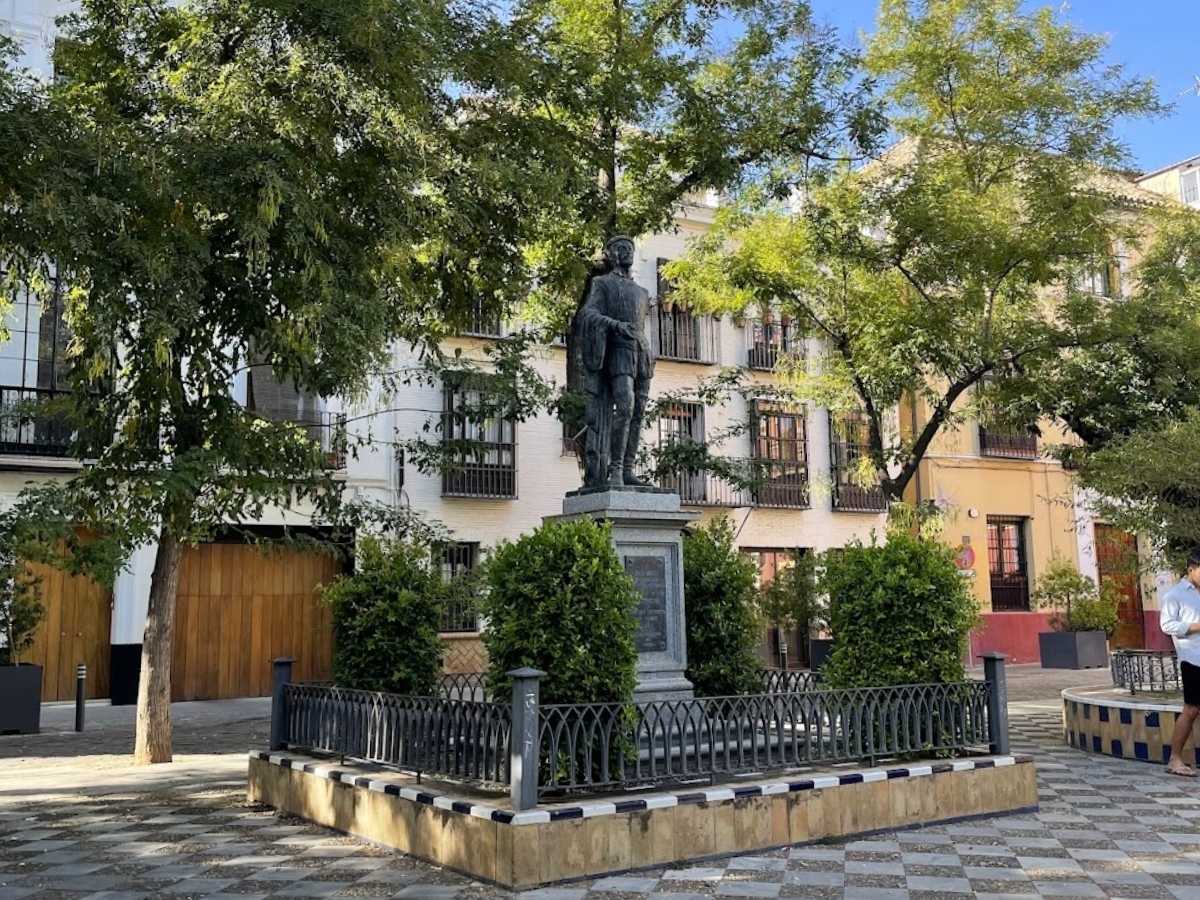 Statue of Don Juan Tenorio surrounded by trees in Plaza de los Refinadores in Seville