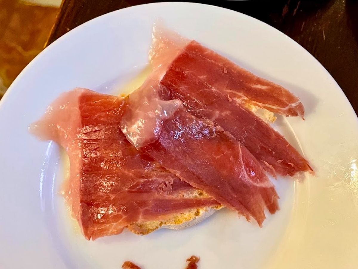 Slices of Spanish jamón ibérico served on toasted bread during a Seville food tour