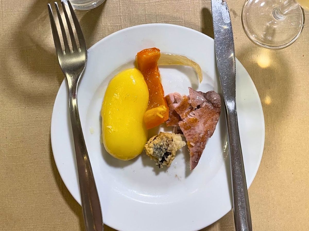 Small plate of traditional Spanish tapas with potatoes, peppers, and meat